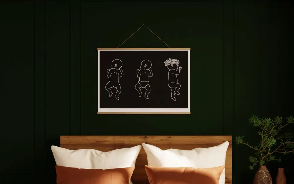 Triplet birth poster in Ink on a natural wood hanger in a green bedroom